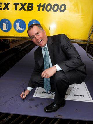Bob Binder signs the first piece of steel cut for Riviera.