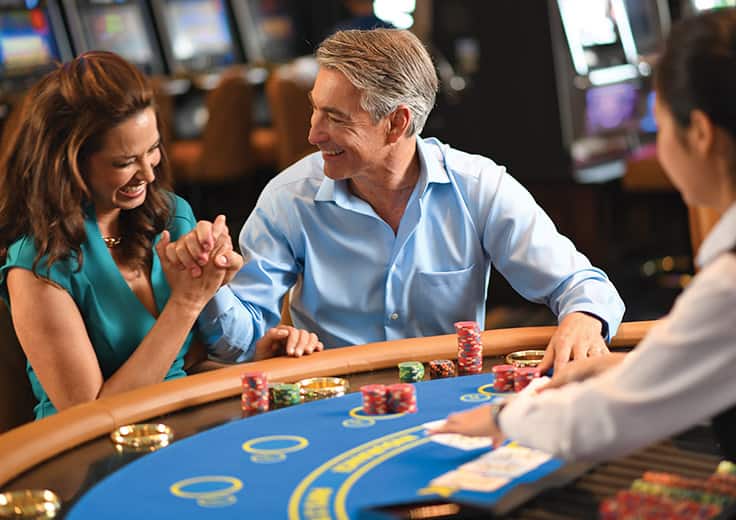 A couple playing blackjack in Nautica's casino