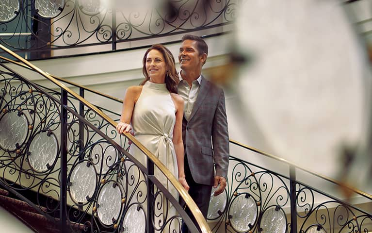 oceania club savings, couple on grand staircase