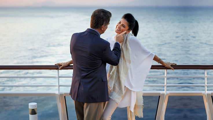 Couple enjoying sunset on terrace on board Regatta