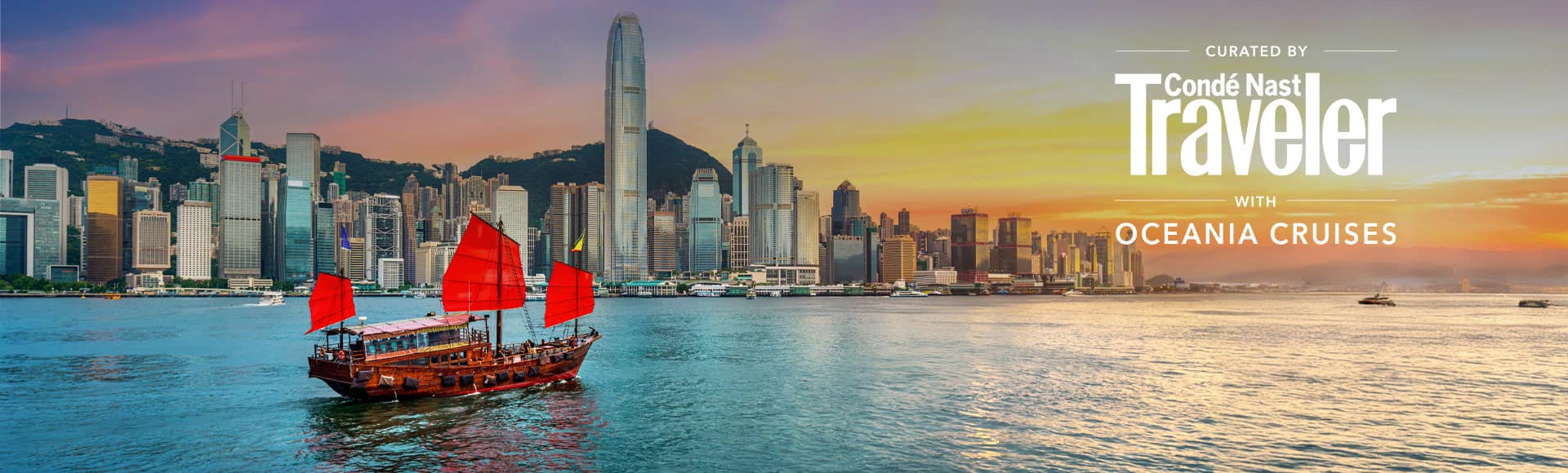 Traditional red-sailed junk boat sailing across Victoria Harbour with the Hong Kong skyline and a golden sunset in the background.