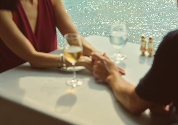 A couple drinking champagne onboard Oceania Cruises