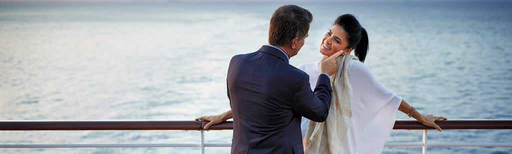 Couple enjoying sunset on terrace on board Regatta